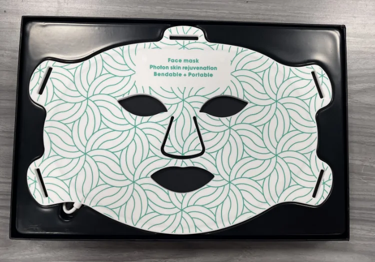 Qcured Red Light Face Mask packed in a retail box tray